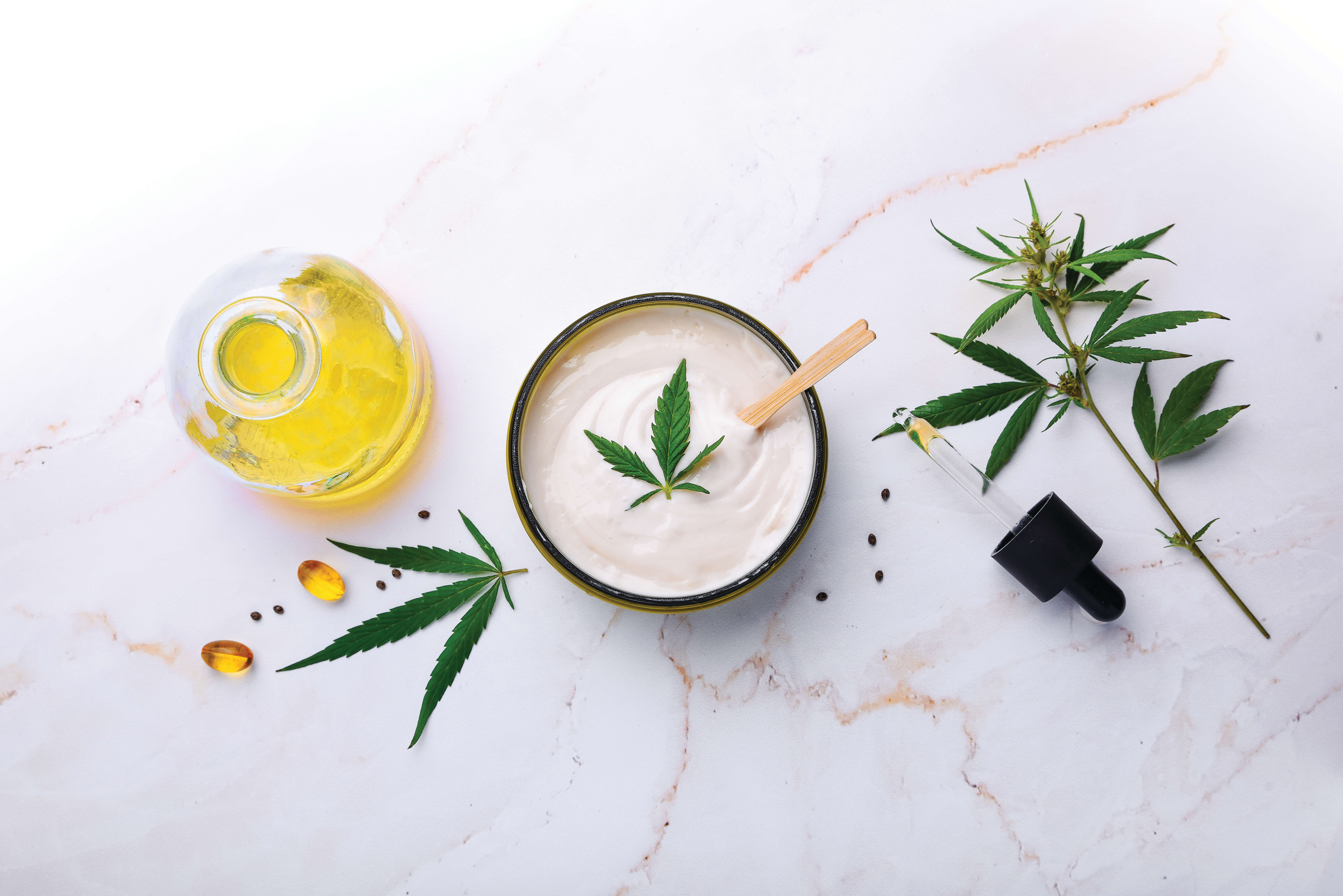 Jar of hemp white lotion. Cannabis cream with marijuana leaf – cannabis concept. Flat lay, top view.