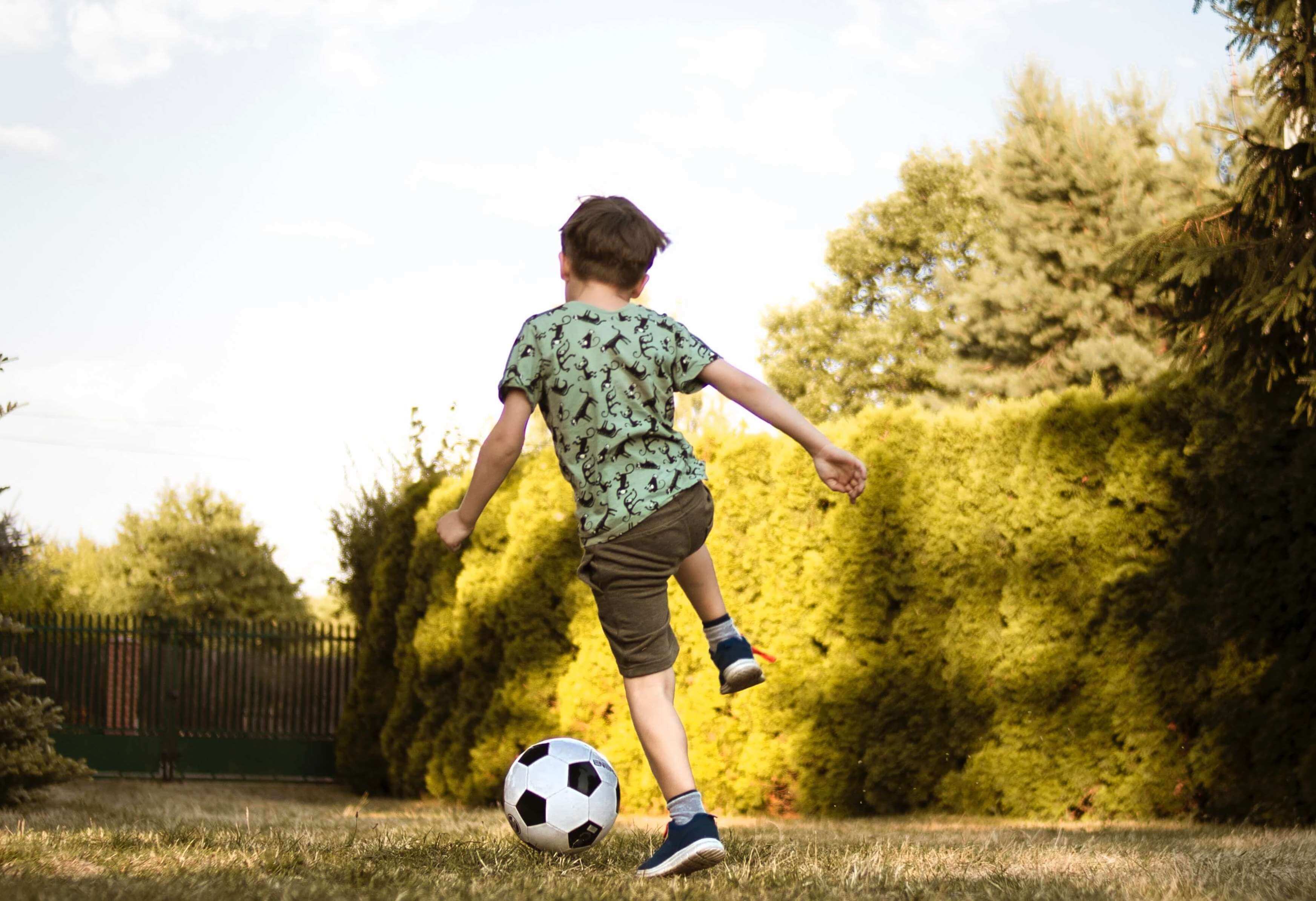 low-angle-photo-of-a-boy-playing-soccer-2682543