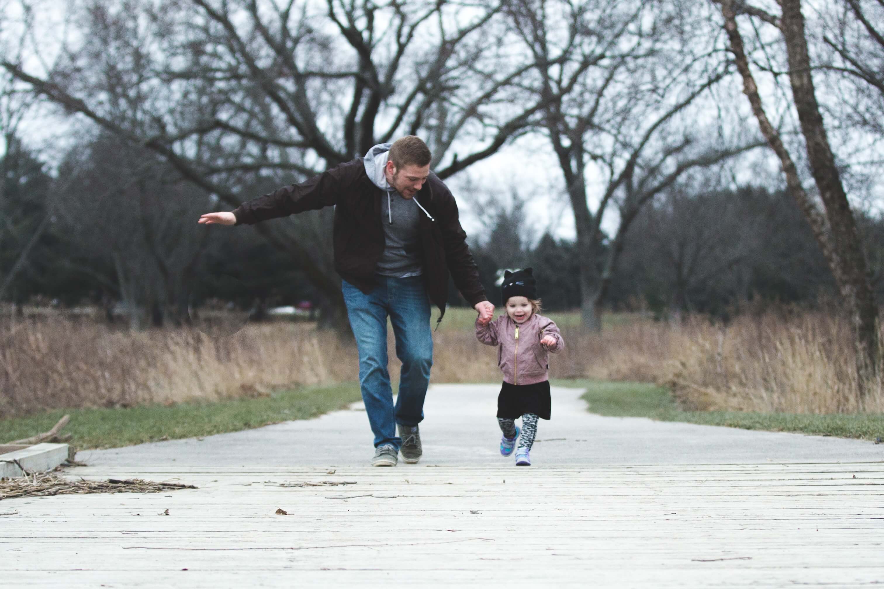 photo-of-father-and-daughter-running-at-the-park-853408