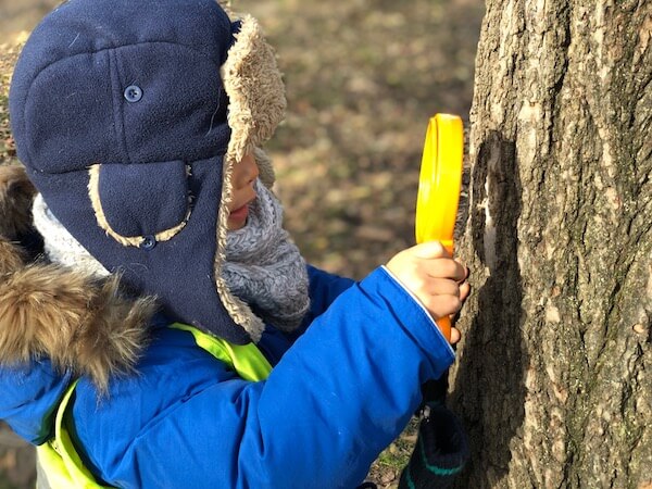 Kid using magnifine glass