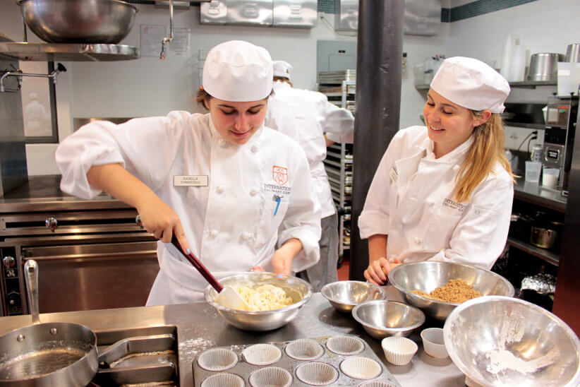 Campers cooking together at the international culinary center