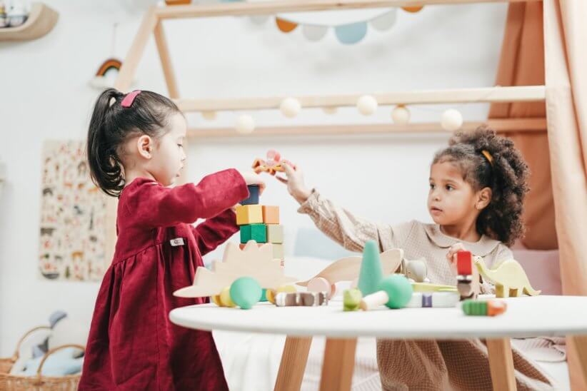 preschool kids playing with toys at the table