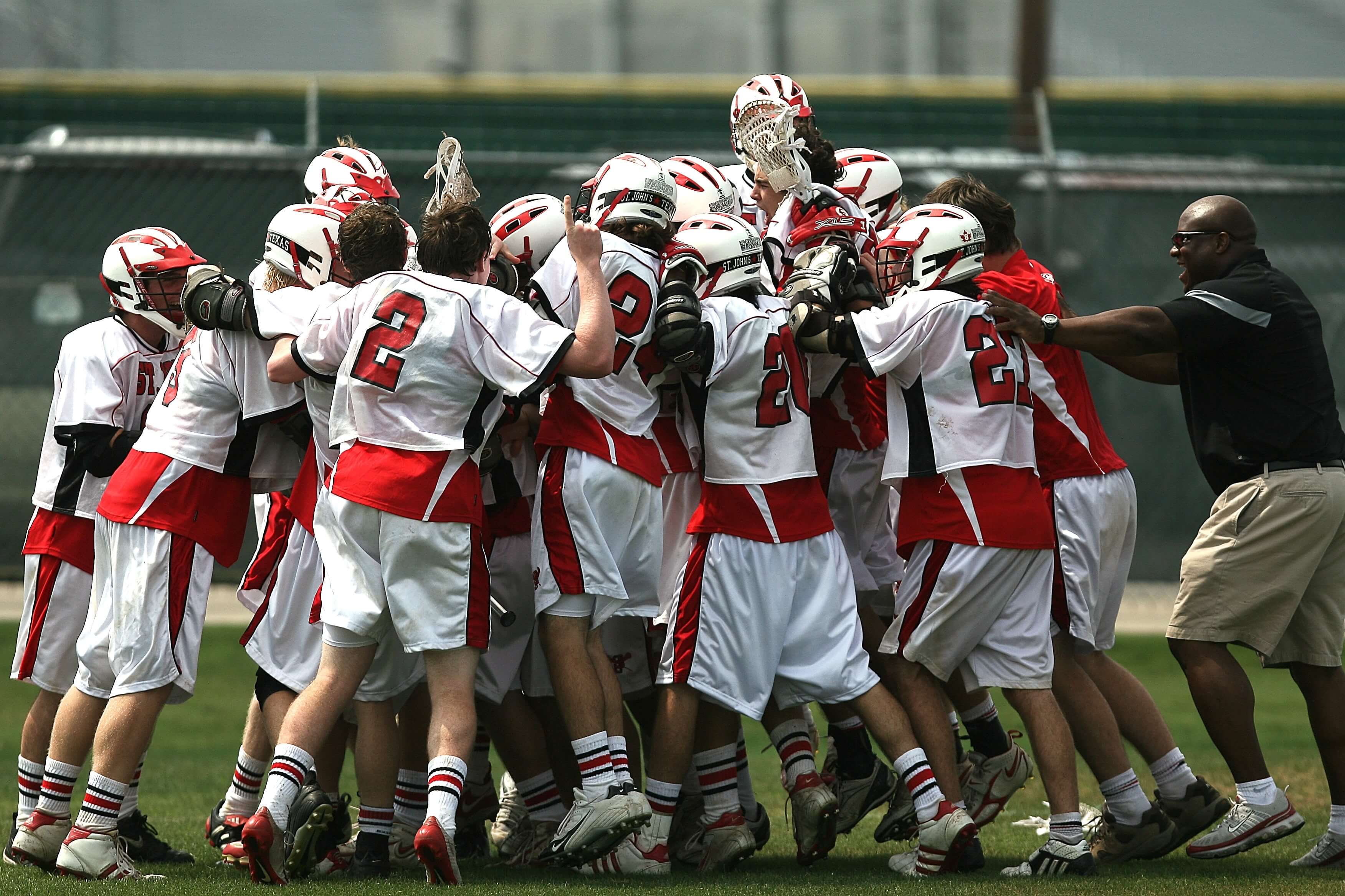 group-of-lacrosse-players-celebrating-with-coach-during-159728