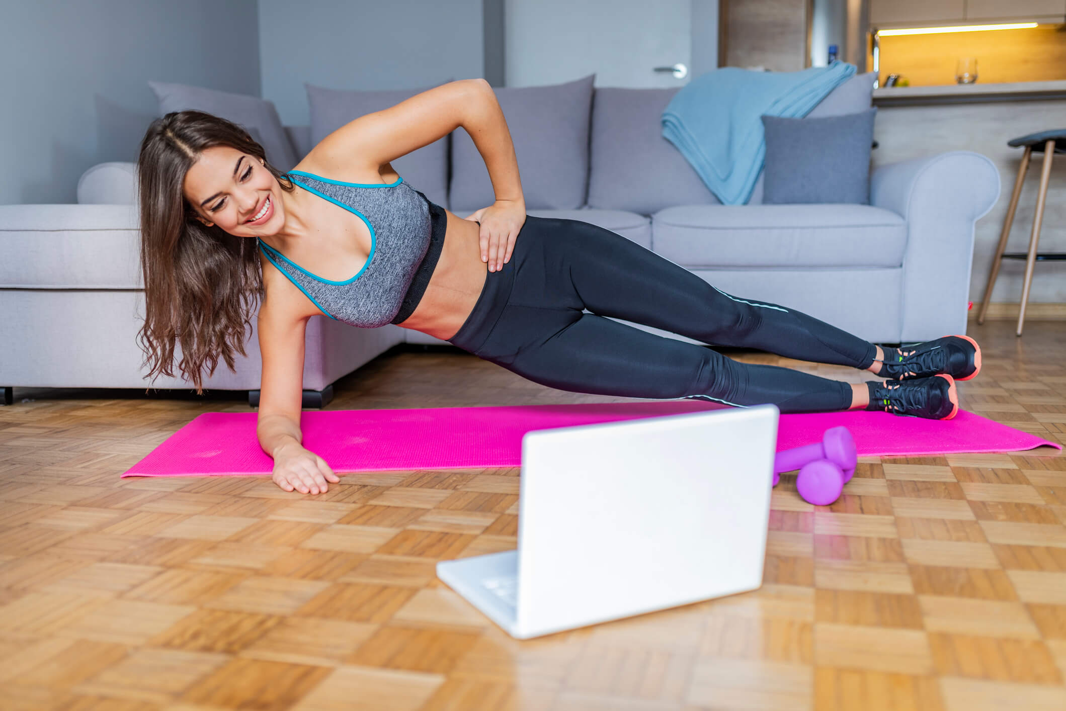 Young woman exercising at home in a living room