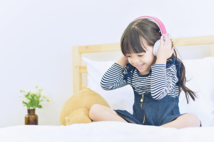 girl listening to kid podcast
