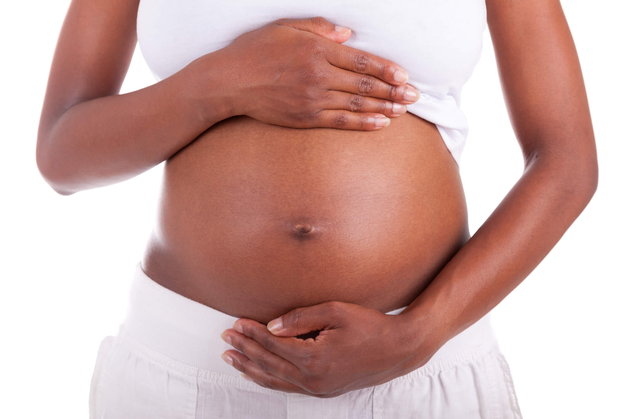 Young pregnant black woman touching her belly – African people