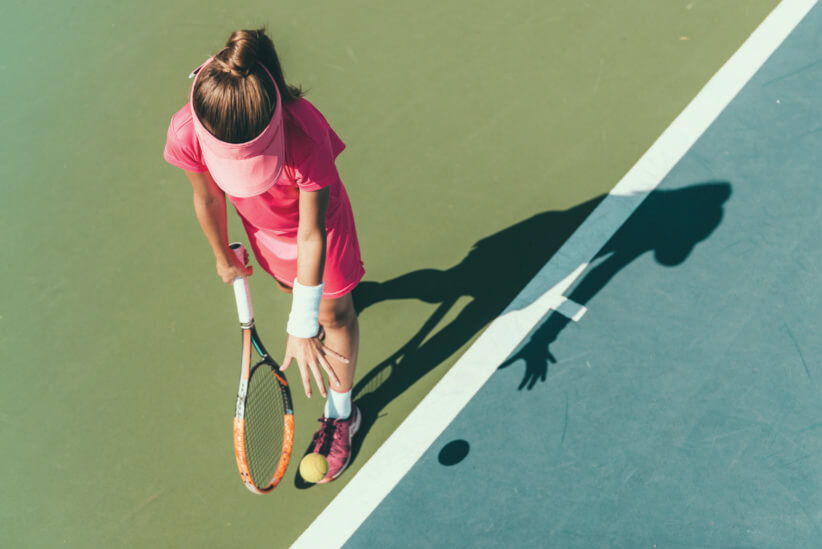 young girl playing tennis