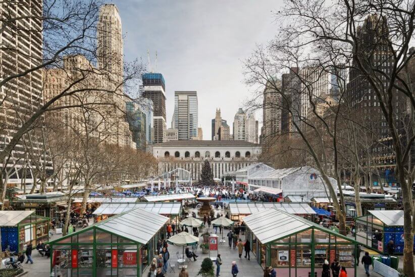 People walking around shops at bryant park winter village