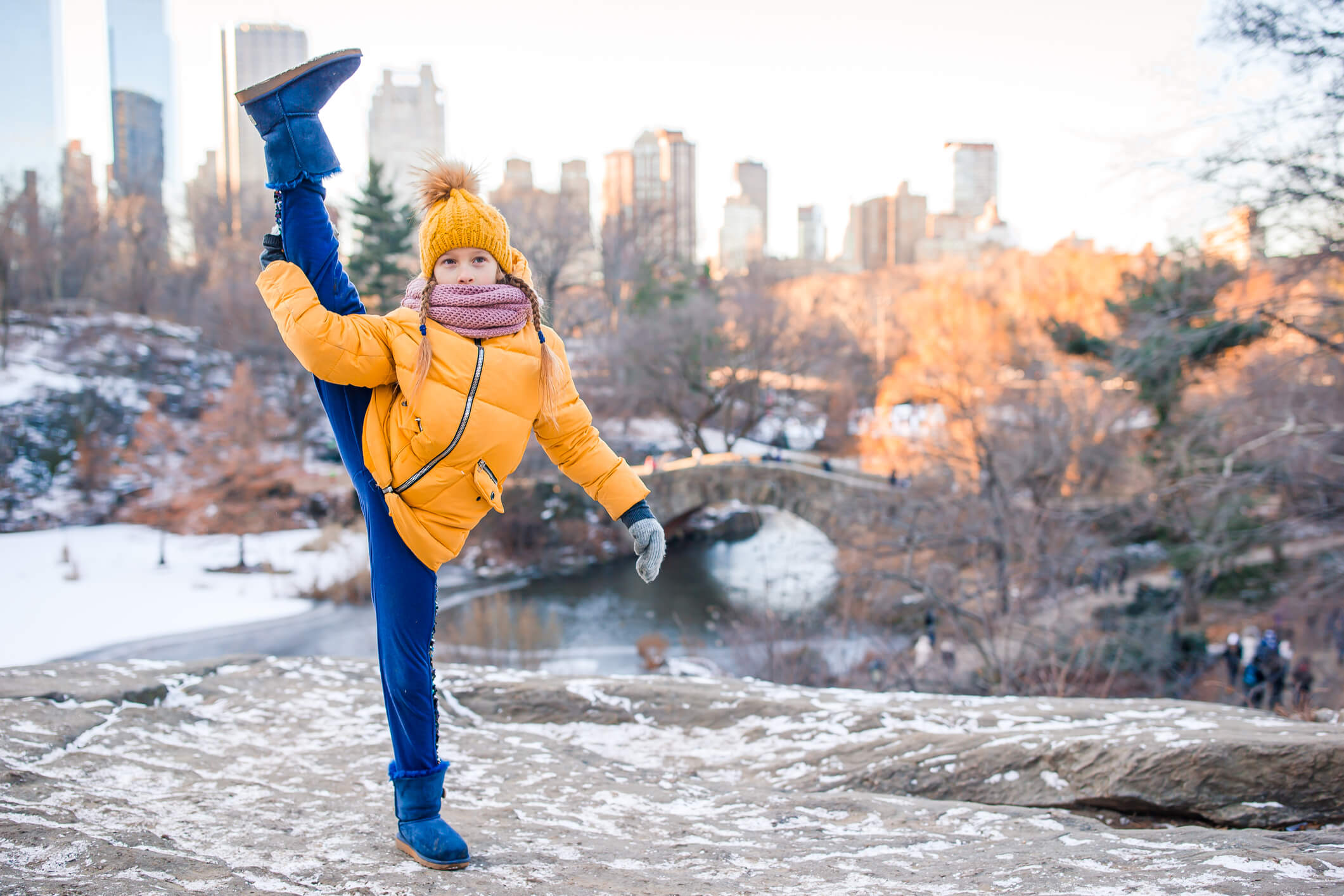 Adorable little girl with view of ice-rink in Central Park at New York City