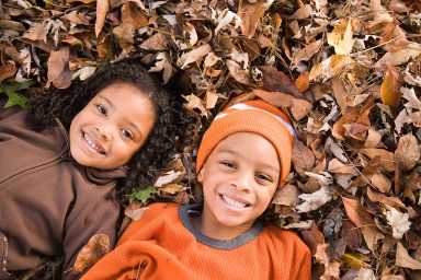 Kids lying on leaves