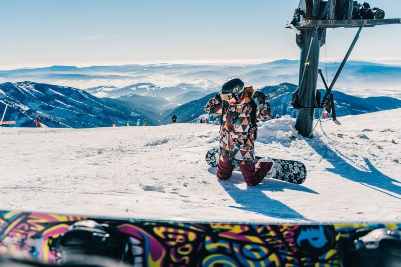 Kid snowboarding in the mountains