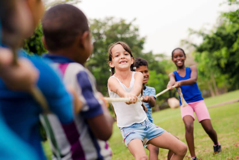 kids playing tug-of-war at camp