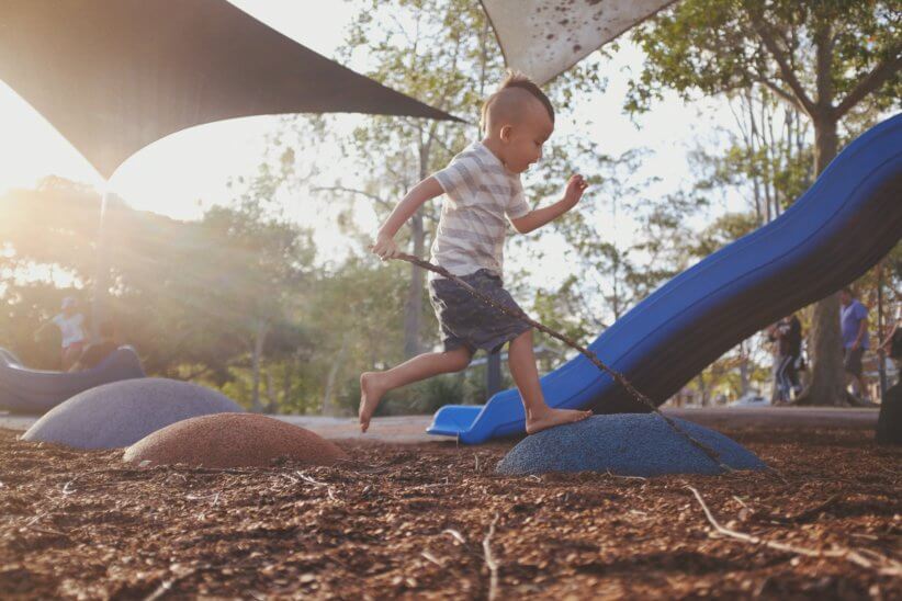 Kid running at one of the inclusive playgrounds