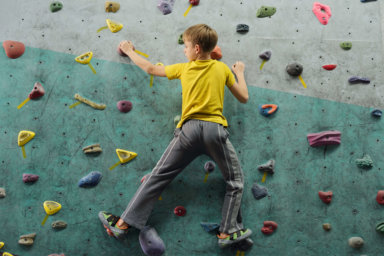 kid climbing at indoor rock climbing in nyc
