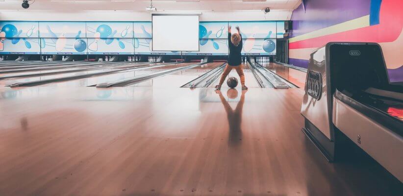 Kids launch balls in bowling alleys