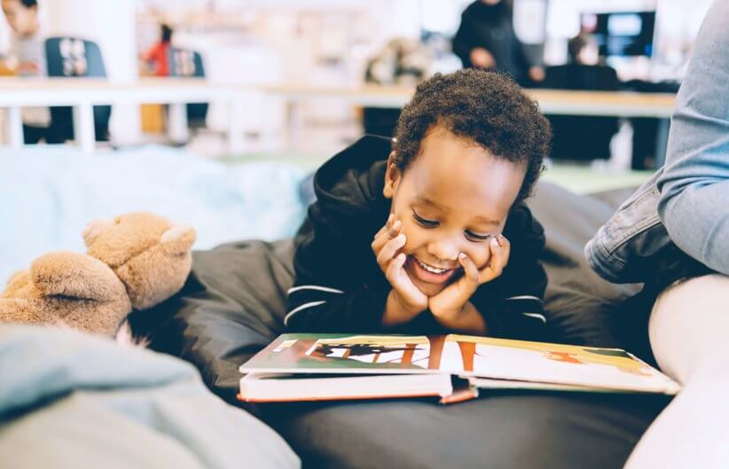 young boy reading book