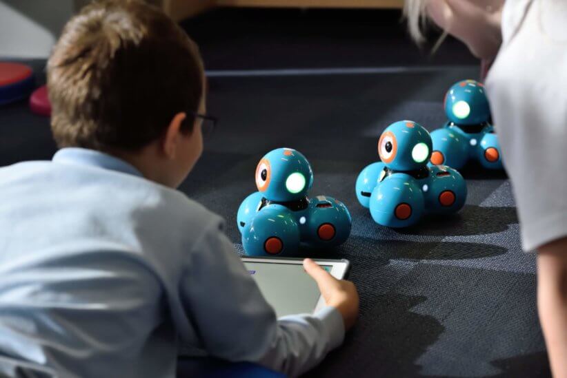 Kid enjoying robots at STEM camp