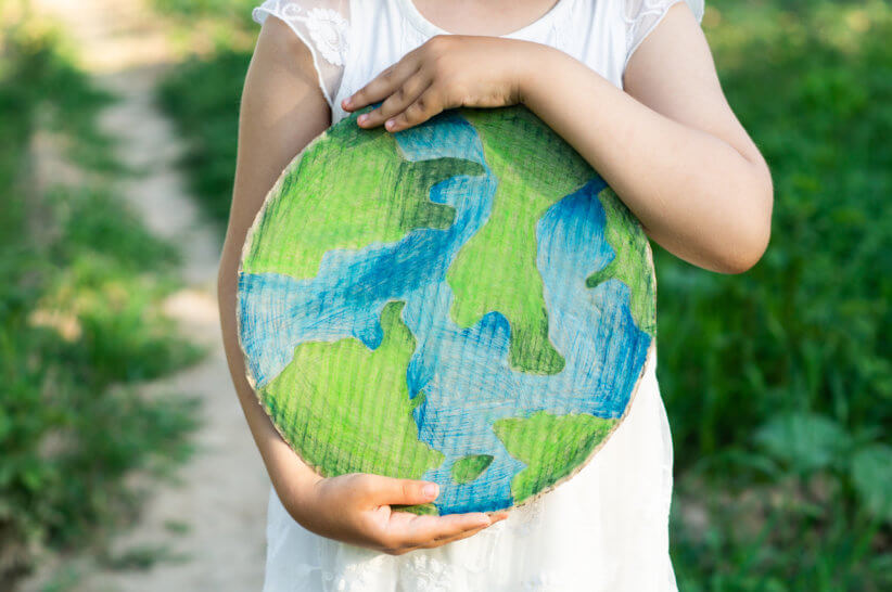 child holding planet for earth day