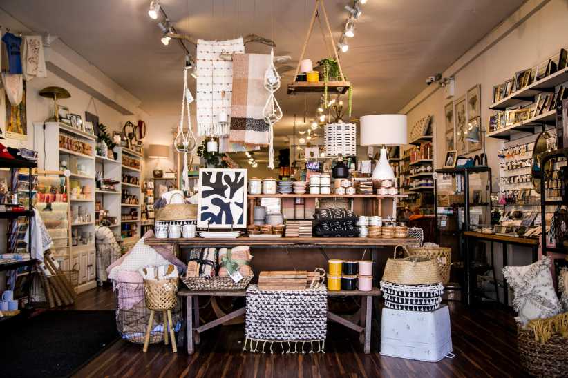 The file "Lockwood-374-822x548.jpg" shows a cozy boutique shop filled with home decor items, baskets, textiles, candles, and gifts arranged on wooden shelves and tables.
