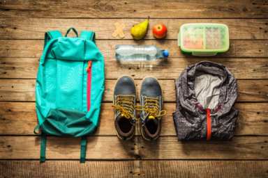 Traveling – packing (preparing) for adventure trip concept