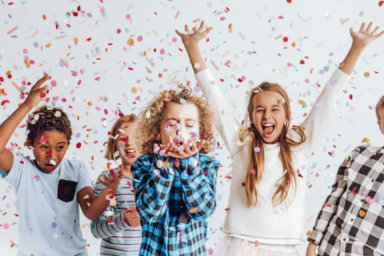 Kids in a room full of confetti