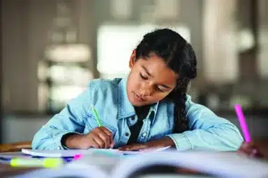 Indian little girl studying at home