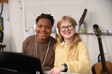 Two students with headphones on