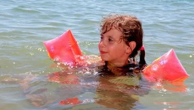 small girl in the ocean