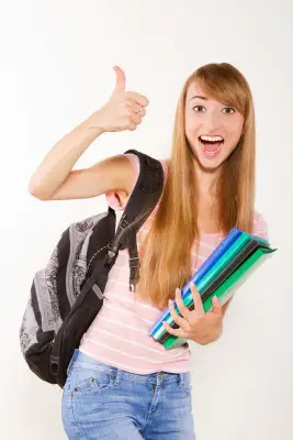 enthusiastic young girl with school supplies