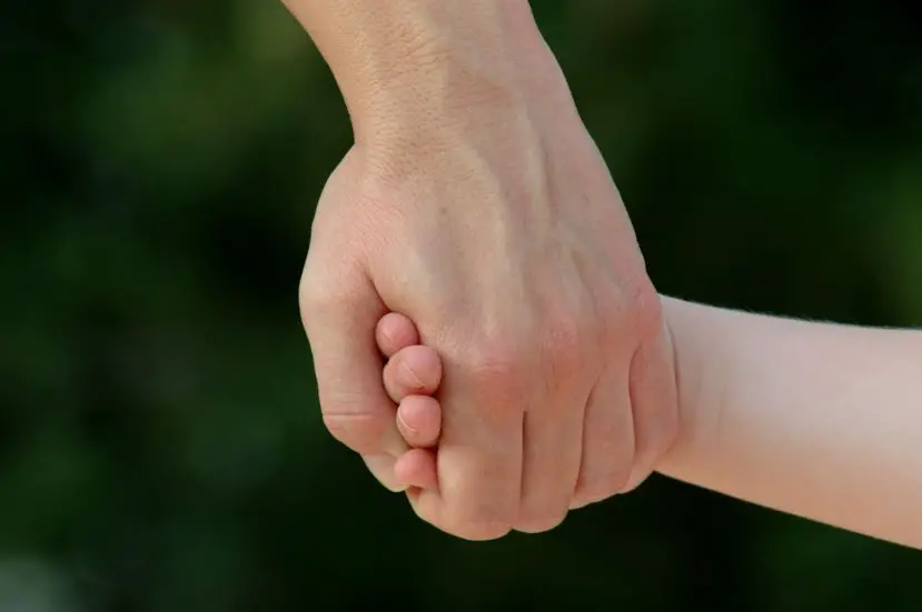 mother holding daughter's hand