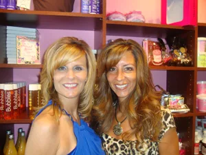 Lisa Falco-Gadzinski and Karen Falco-Pedra in front of the Bath Bakery Sweet Shoppe at A Girl's Gotta Spa in Patchogue, Long Island, NY