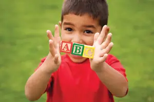 little boy with abc alphabet blocks