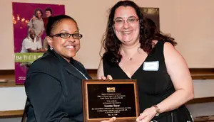 Foster parent Loretta Taylor receives her award from ACS Deputy Commissioner Lorraine Stephens