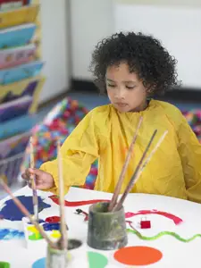 child in art class; young girl painting, arts and crafts; after-school activities
