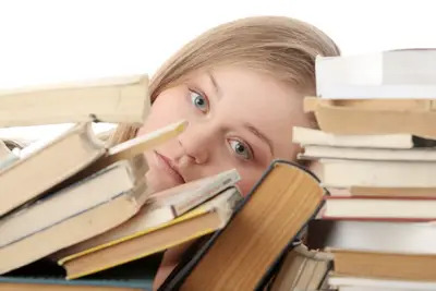 young girl, student surrounded by books