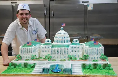 Bay Ridge Bakery owner Nick Nikolopoulos with Congresswoman Carolyn Maloney's birthday cake.