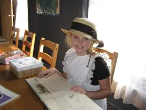 Bayside Historical Society children's room; little girl dressed in historical clothing