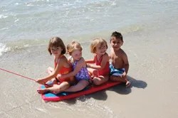 kids on the beach; children playing on the beach, near the ocean