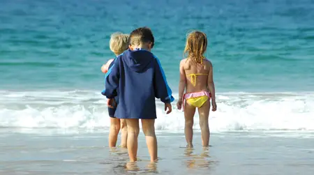 kids at the beach; children playing in the ocean