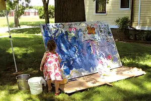 little girl painting outside; young girl doing art outside