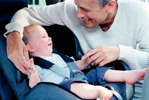 dad with infant in car seat; father and baby in car