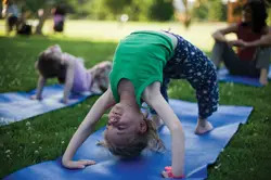 little girl doing yoga; family yoga; child in Upward Bow pose