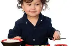 Kid Eating with Chopsticks