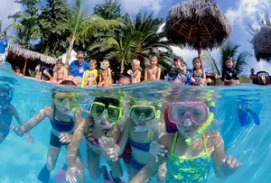 young girls snorkeling in the pool at a resort in Curacao