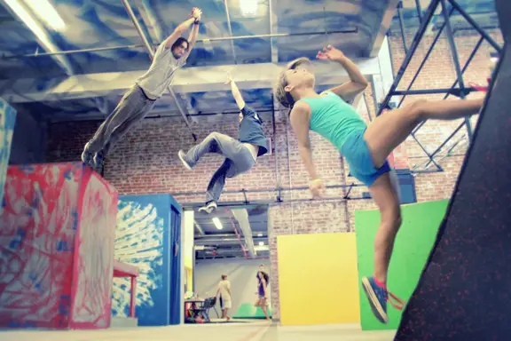 Student Ava Spartachino and instructors Joe Cannato and Murphy Betancourt show off their Parkour skills.
