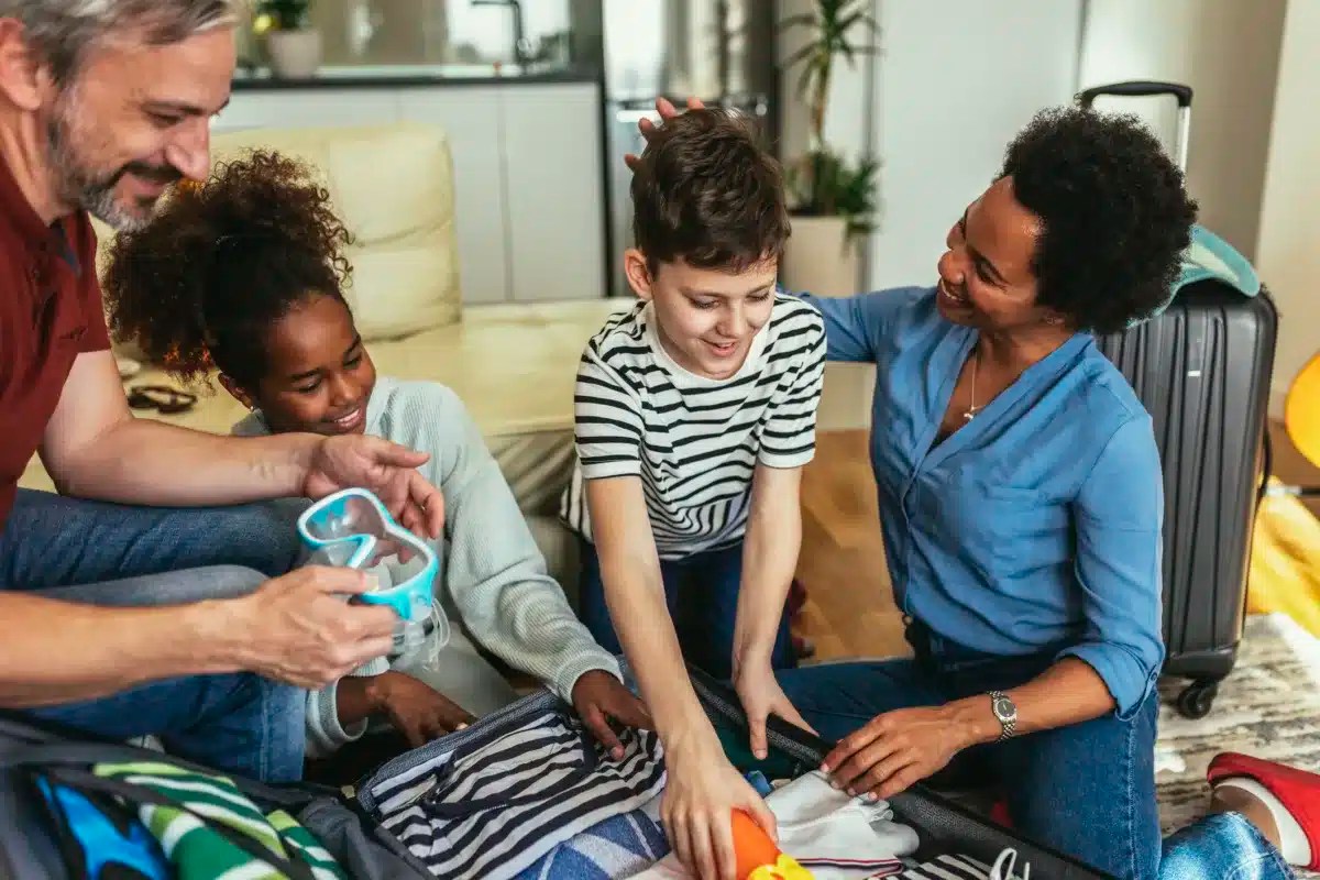 Happy family having great time and packing for summer holidays