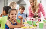 girl at party eating cupcake