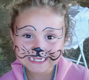 face painting; child with face painted like a cat