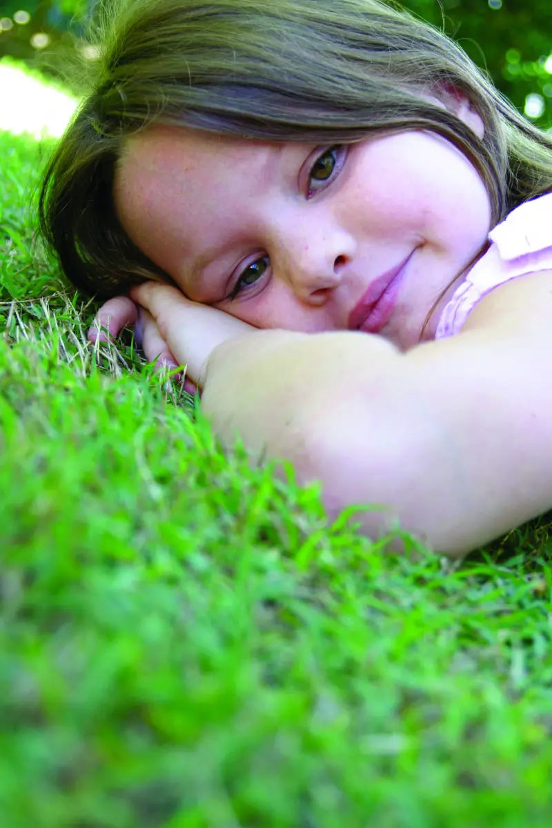 Young girl resting on the grass