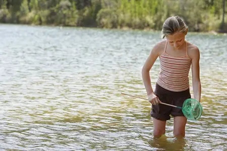 Teatown Lake Reservation; young girl wading in a lake with a net; girl fishing with a net